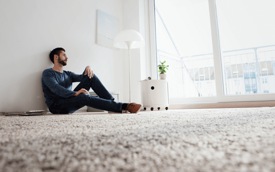 man sitting on carpet